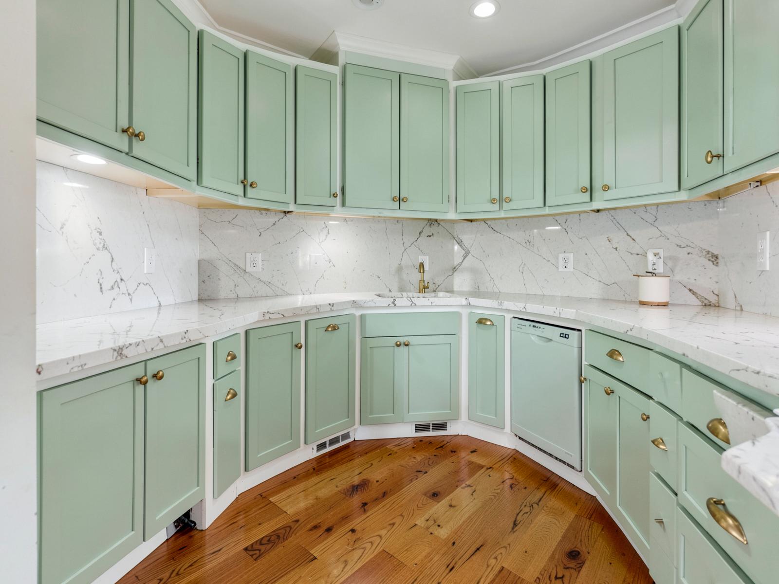 Sea glass painted shaker kitchen with brass hardware