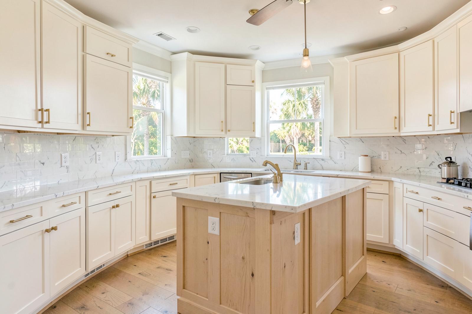 Renovated kitchen with warm white shaker cabinets and white oak island